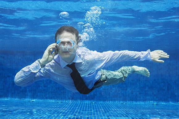 A Businessman Underwater on the Phone