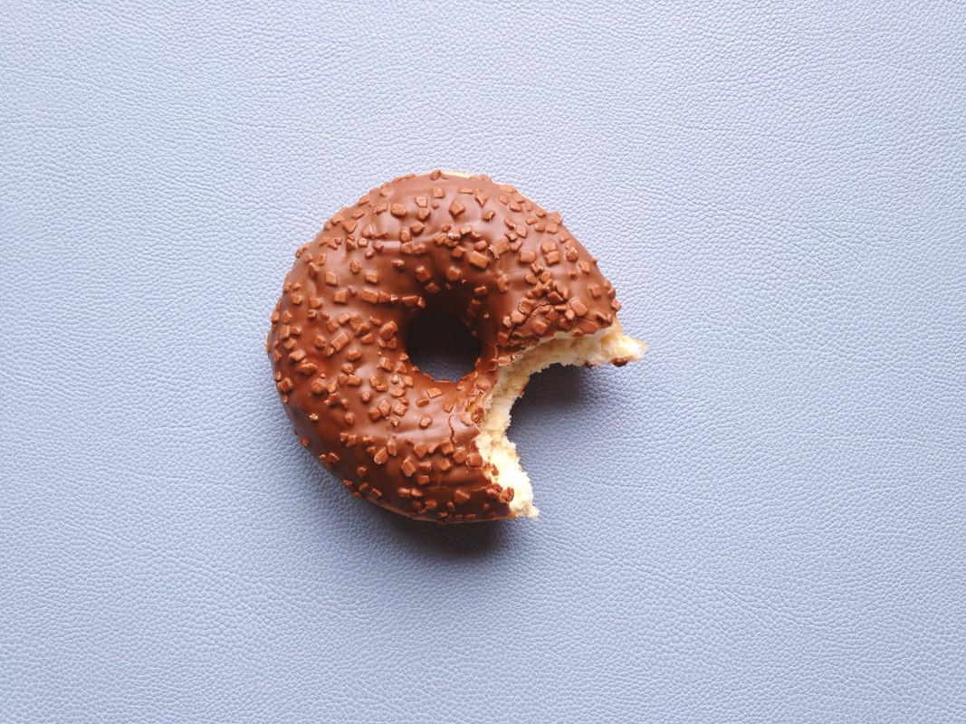Chocolate Glazed Donut or Doughnut with Bite Missing