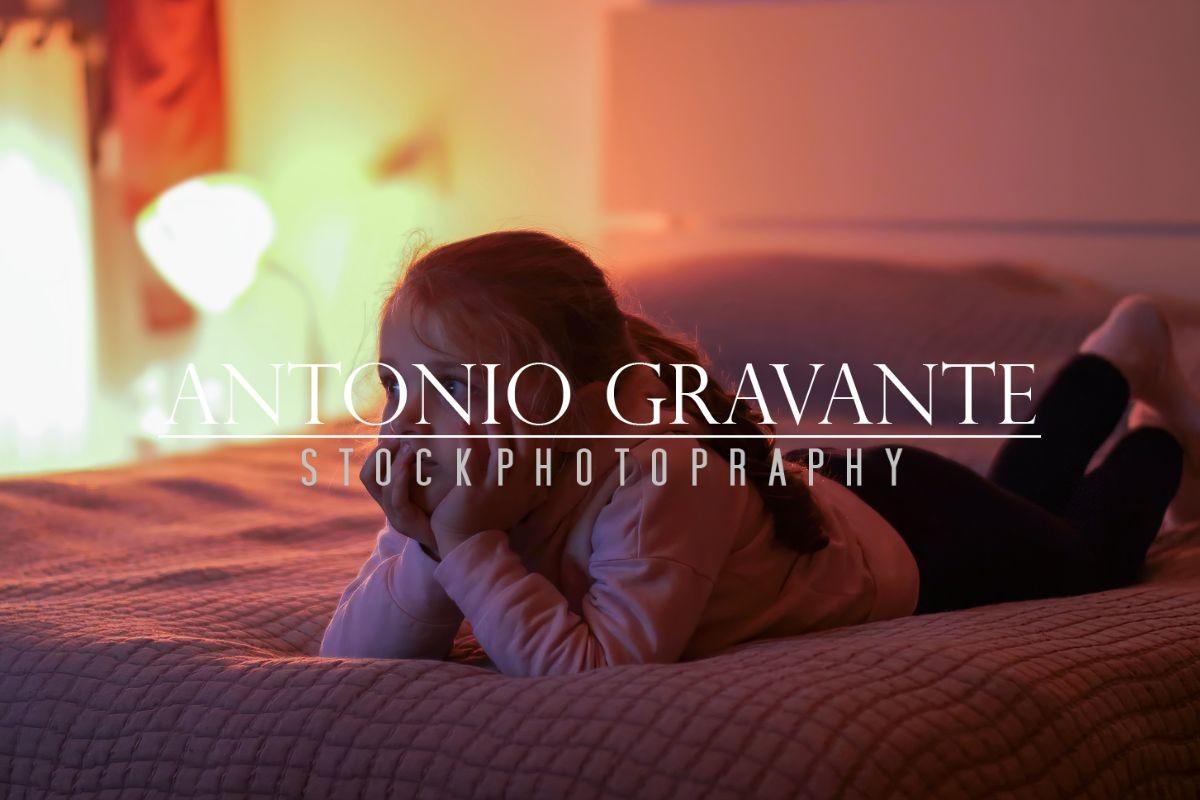 Little Girl Watching Tv in the Bedroom