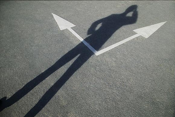 Businessman Standing in from an Arrow